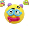 A yellow squishy toy shaped like a dog face with purple ears and a pink tongue.