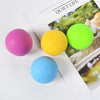 Five colored stress relief balls—pink, yellow, lime green, and blue—are displayed on a white surface.