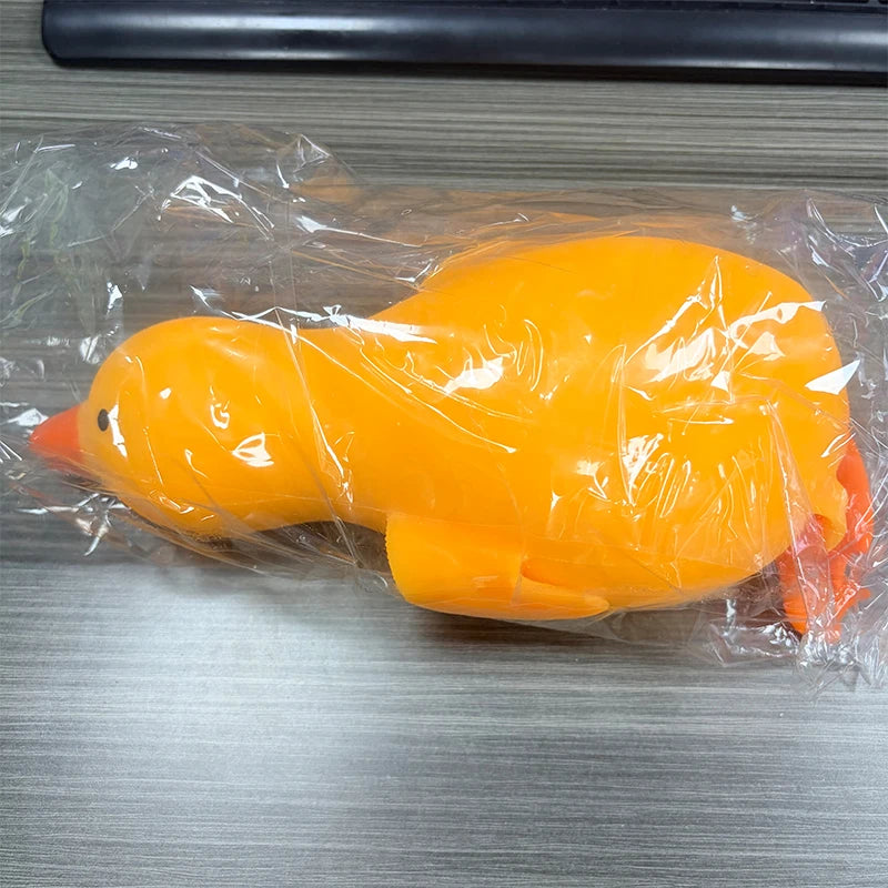 An orange jumbo duck squishy stress relief toy sealed in clear plastic.