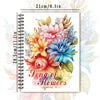 A spiral-bound colouring book featuring a floral design with various flowers and leaves.