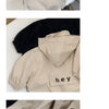 A beige kids hooded zip-up jacket with a black letter print on the chest.