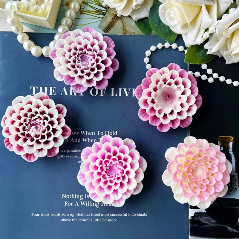 Pink and white flower silicone molds for candle, soap, and resin crafting displayed on a dark blue surface.