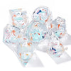 A set of seven clear resin polyhedral dice featuring pink floral butterfly designs for tabletop role-playing games