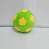 A single handmade crochet hacky sack ball in bright lime green with yellow accents.