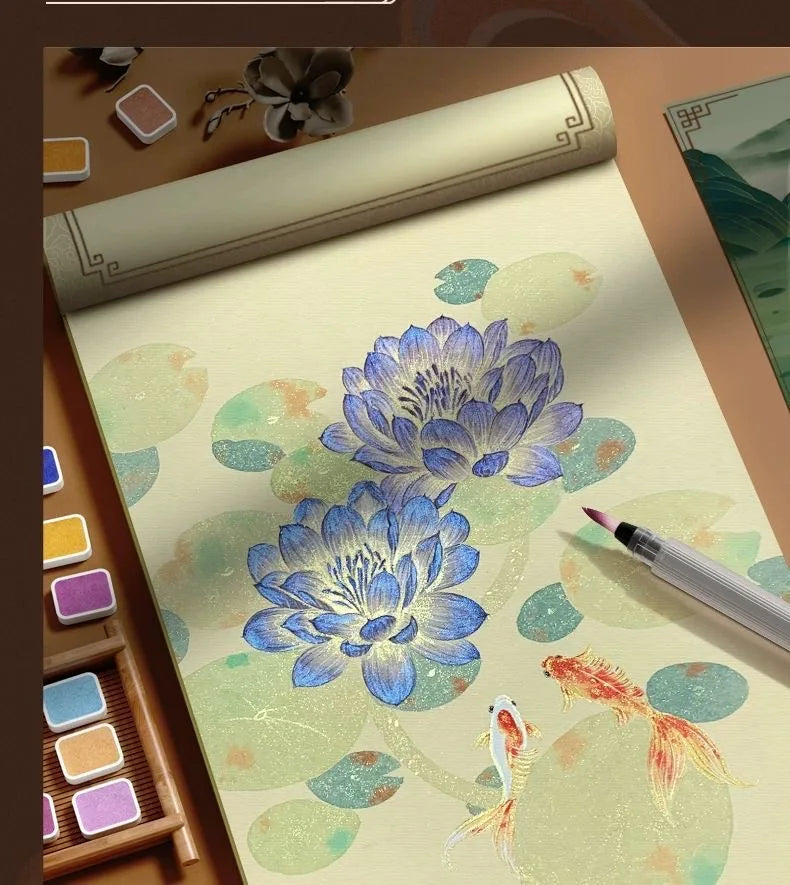 A watercolor paint set featuring blue flowers and a goldfish on textured paper, displayed with brushes and paint pots.