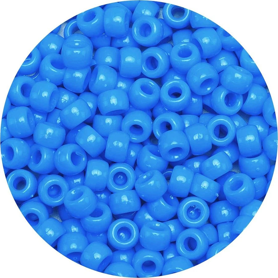 A pile of small, round blue pony beads for jewelry making