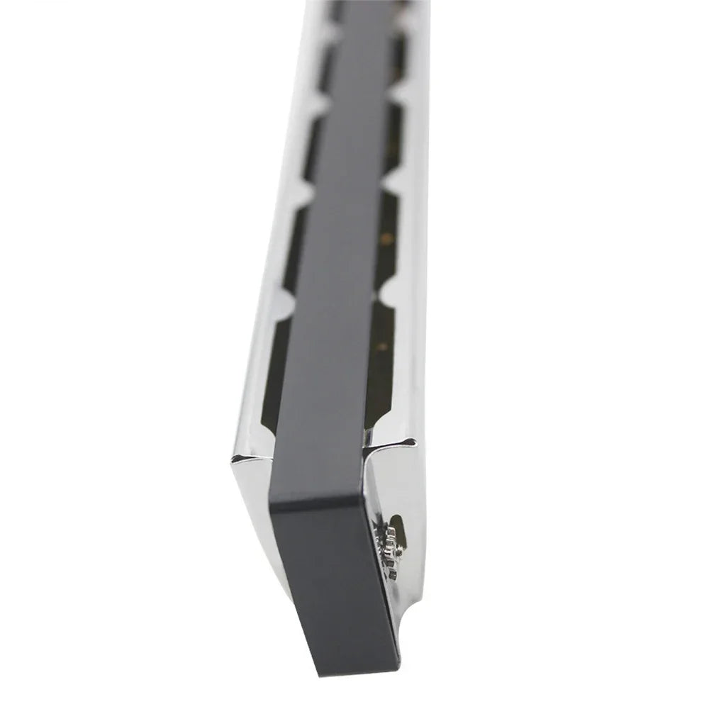 A silver 24-hole tremolo harmonica in C with a protective case shown from the side.