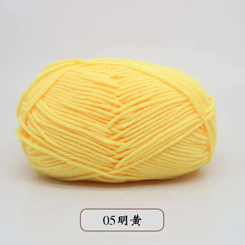 A ball of bright yellow pre-dyed milk cotton yarn for knitting and crochet.