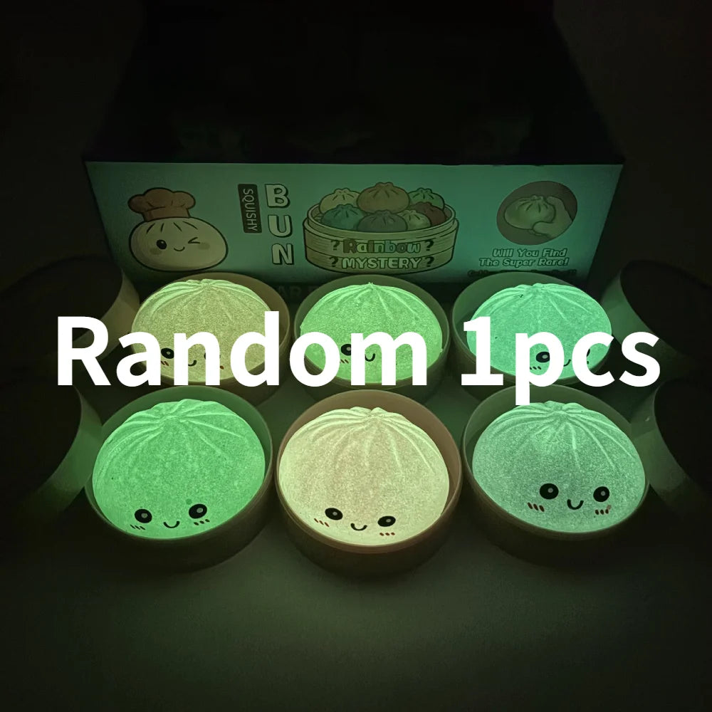 A collection of ten glowing green squishy dumpling toys displayed in a box.