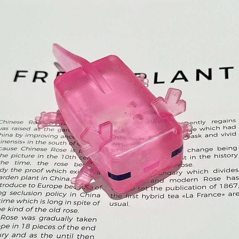 A pink squishy toy shaped like a jellyfish, used for sensory stress relief or fidgeting.
