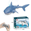 A blue shark toy is shown alongside a remote control, demonstrating its light and water spray features.