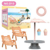 A miniature dollhouse furniture set featuring a pink bathroom or kitchen playset with chairs and accessories.
