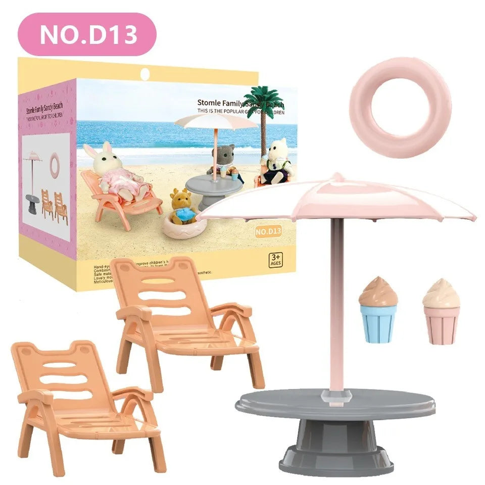 A miniature dollhouse furniture set featuring a pink bathroom or kitchen playset with chairs and accessories.