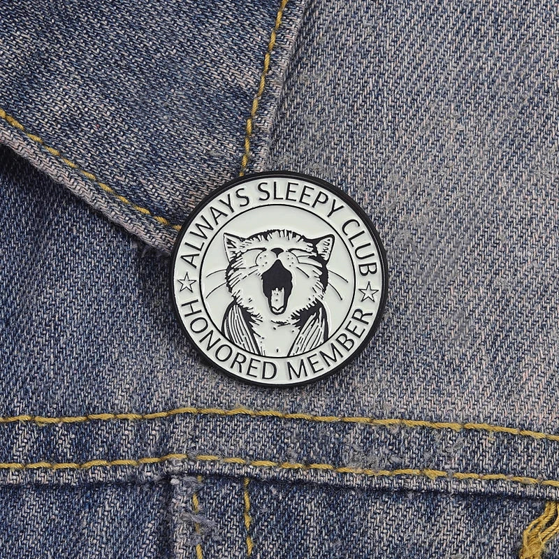 Enamel pin featuring a yawning cat design for an honored member of the Always Sleepy Club