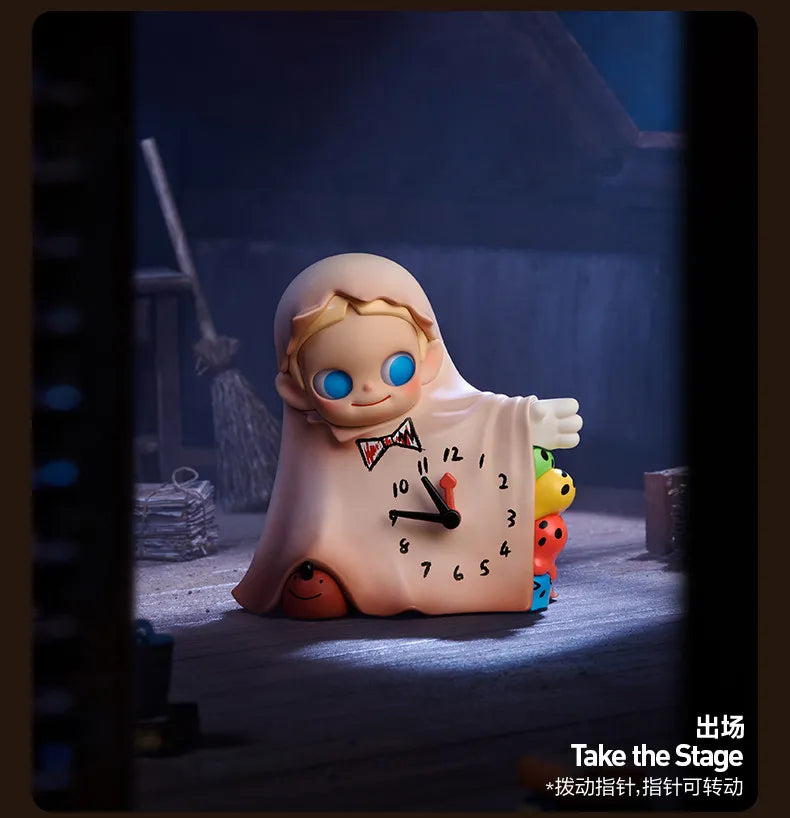 A blind box collectible figure of a smiling baby with blue eyes and light pink clothing sitting on a surface.