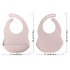 A pair of light pink waterproof silicone baby bibs with adjustable necks shown from the top and side.