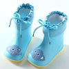 A pair of light blue kids rain boots with laces and a cute elephant design on the toe.