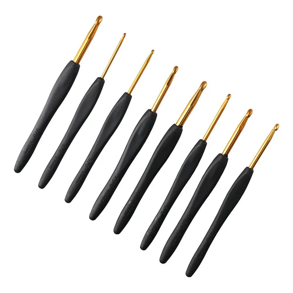 A set of eight ergonomic crochet hooks with black grips and gold tips.
