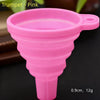 Pink silicone trumpet funnel with a handle, shown against a dark background.