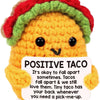 Handmade crochet taco plush toy with a colorful hat and a positive message