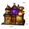 A detailed miniature dollhouse kit of a seaside beach house featuring wooden structures and LED lights.