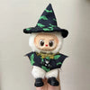 A cute doll wearing a witch costume with a black pointed hat and green bat patterns on a black dress.