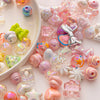 A collection of iridescent and pastel acrylic bow and flower beads for DIY jewelry making.