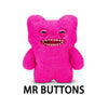 A bright pink plush monster with large eyes and a wide, toothy grin.
