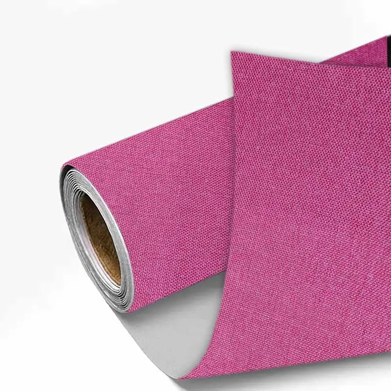 Rolls of magenta linen book binding cloth used for albums and scrapbooks