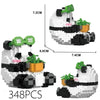 A white panda figure built from LEGO bricks with black accents and green accessories.