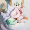 A collection of squishy stress relief balls in various pastel colors including purple, pink, green, and orange.