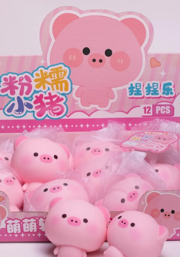A box of pink pig squishy stress relief toys with a cartoon pig illustration.