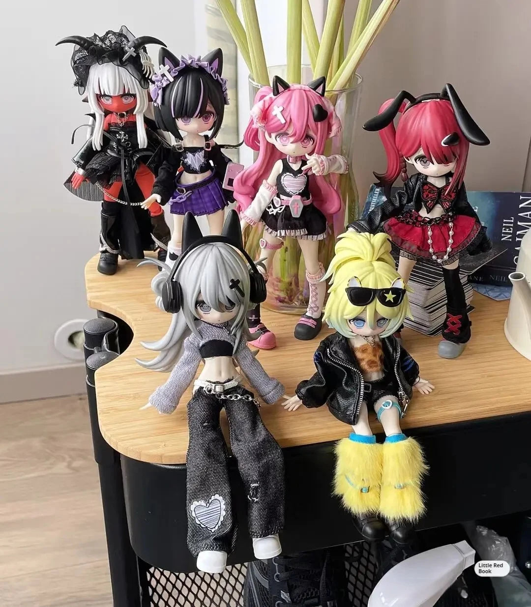 A collection of seven articulated vinyl art figures from the Escape Plan Series mystery box featuring various characters and 
