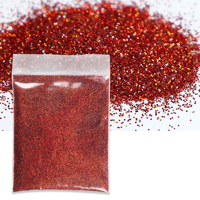 A sealed bag of fine, holographic red glitter powder next to a pile of loose red glitter.