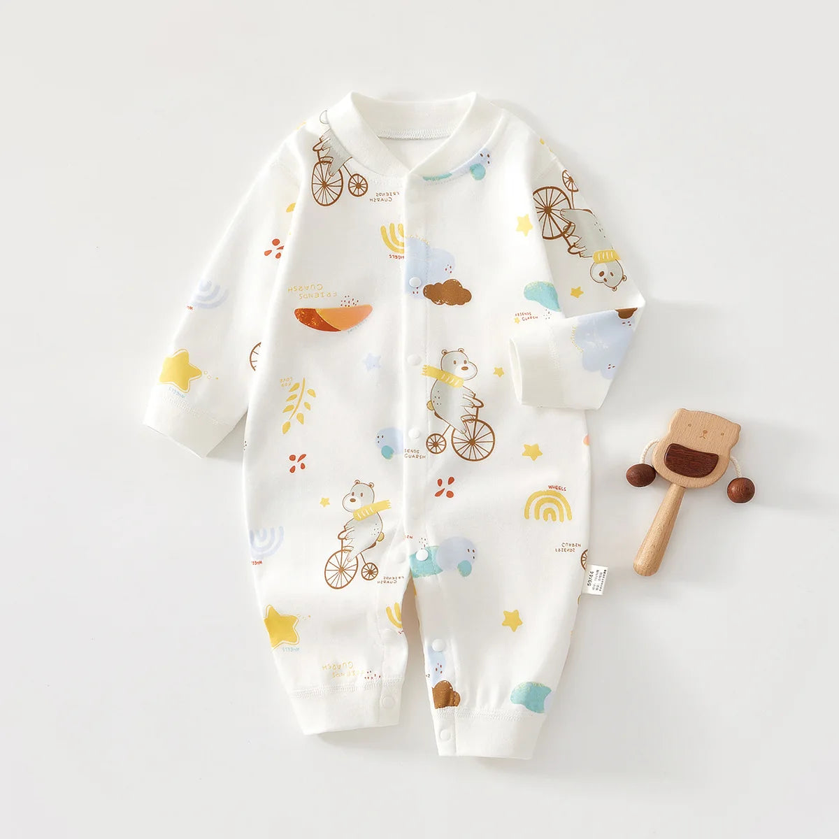 A white cotton long sleeve baby romper featuring illustrations of bicycles, clouds, and nature elements for spring and autumn