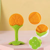 A bright orange silicone fruit-shaped baby teether with a green handle and base.