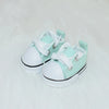 A pair of light mint green casual sneakers for 17cm Labubu dolls, shown from above.