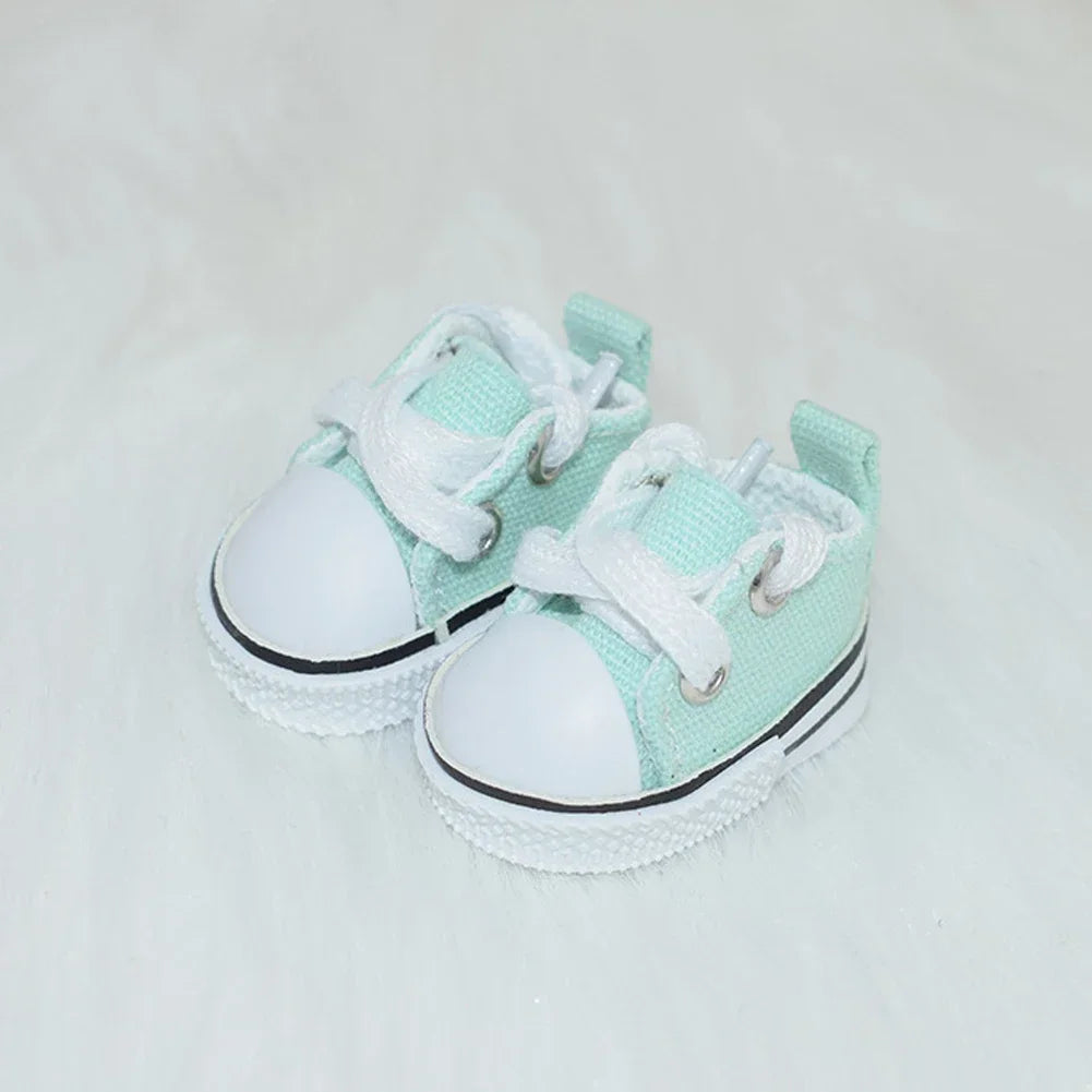 A pair of light mint green casual sneakers for 17cm Labubu dolls, shown from above.