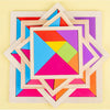 A colorful wooden tangram puzzle set featuring seven geometric pieces arranged in a star pattern on a light background.