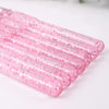 A close-up view of a 7-piece pink aluminum crochet hook set with color-coded handles arranged diagonally.