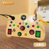 A yellow Montessori busy board with various switches and an LED light, used for toddlers.