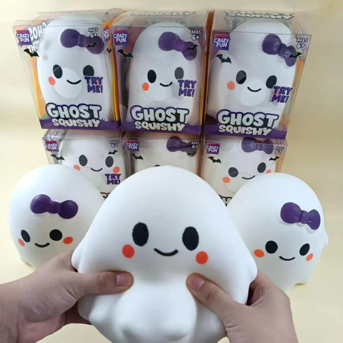 A hand holds a white ghost squishy stress relief toy next to its packaged versions.