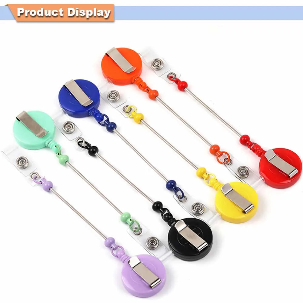A display of various beadable badge reels with retractable clips in colors including orange, blue, green, and red.