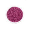 A clear container filled with small, round, purple glass seed beads for jewelry making.
