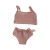 A pink knitted doll outfit set for a baby doll featuring a top and bottoms.
