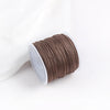 A roll of brown cotton nylon macrame cord for jewelry making and crafts.