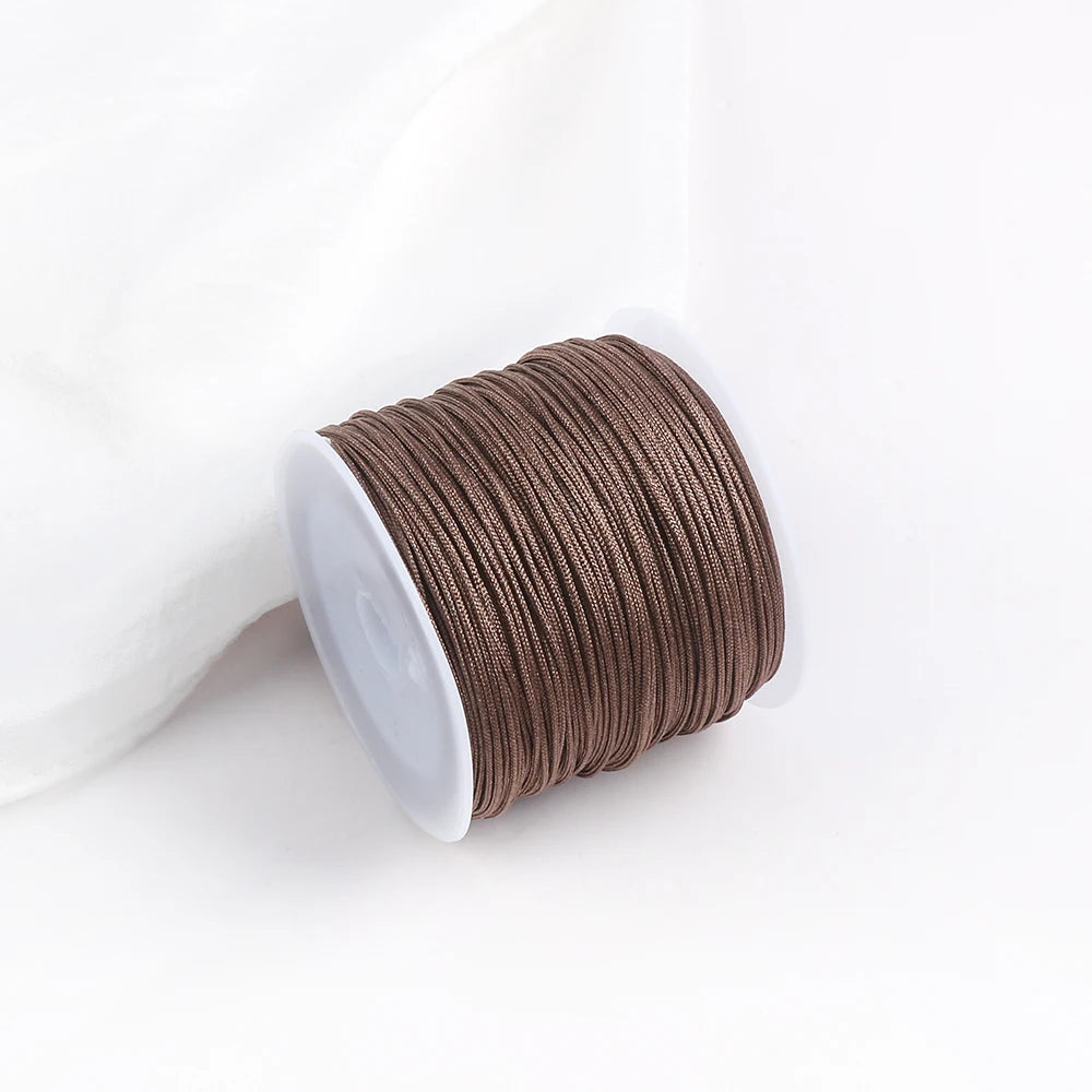 A roll of brown cotton nylon macrame cord for jewelry making and crafts.