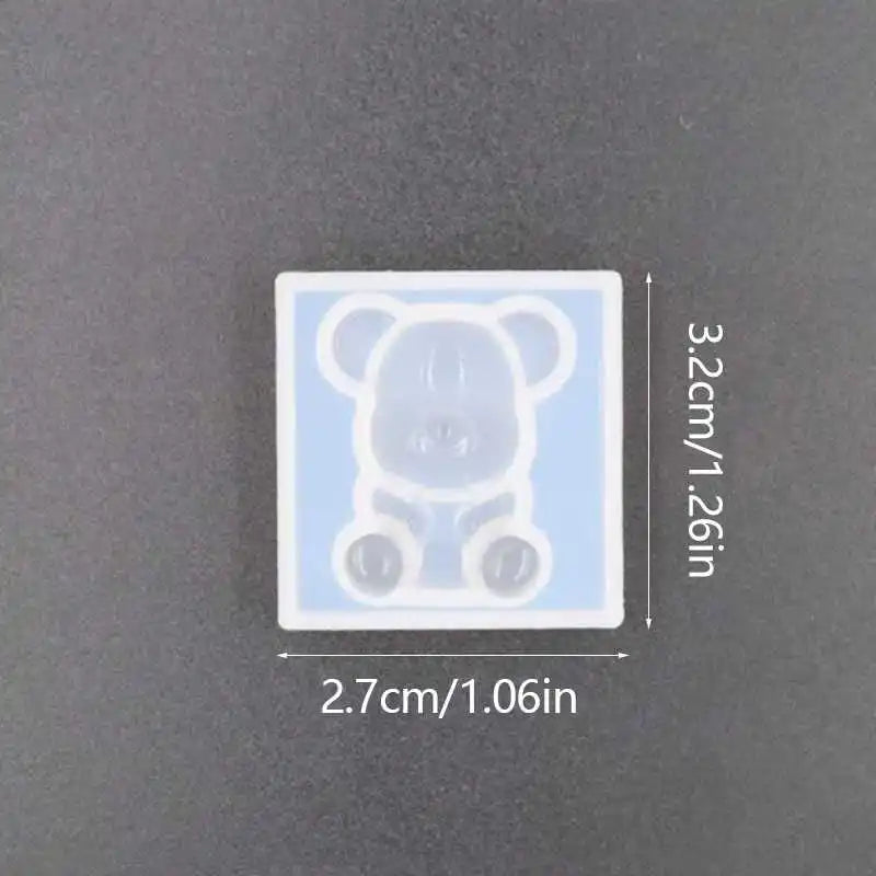 A white silicone mold shaped like a bear for resin jewelry and crafts.