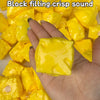 A hand is squeezing a bright yellow, squishy cheese stress ball for ASMR or fidgeting.