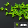 A pile of bright green building block treasure chest pieces, including gold and silver coins, on a dark surface.